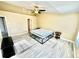 Bright bedroom with a ceiling fan, light hardwood floors and a corner window at 12249 Country White Cir, Tampa, FL 33635