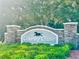 The elegant stone entrance to Country Chase, featuring lush greenery, creating an inviting atmosphere at 12249 Country White Cir, Tampa, FL 33635