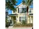Charming two-story home featuring a covered porch, neat landscaping, and a bright yellow facade, perfect for suburban living at 12249 Country White Cir, Tampa, FL 33635