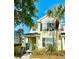 Charming two-story home with yellow siding, black shutters, and well-maintained landscaping at 12249 Country White Cir, Tampa, FL 33635