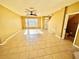 Open living room with tile flooring, ceiling fan, and natural light creates a bright and inviting space at 12249 Country White Cir, Tampa, FL 33635