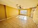 Spacious living room featuring tile flooring, a ceiling fan, and a window with natural light at 12249 Country White Cir, Tampa, FL 33635