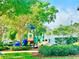 Community playground with colorful equipment and lush greenery is the perfect place for outdoor fun at 12249 Country White Cir, Tampa, FL 33635