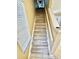 Staircase featuring neutral walls, wooden stairs, and a window with natural light at 12249 Country White Cir, Tampa, FL 33635