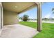 Back patio with green grass and fenced yard at 13408 Nimble Minke # 155E, Riverview, FL 33579
