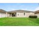 A well-maintained backyard with lush green grass and a covered patio at 13408 Nimble Minke # 155E, Riverview, FL 33579