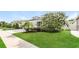 Beautiful home boasting lush green lawn, mature landscaping, and a charming exterior at 13408 Nimble Minke # 155E, Riverview, FL 33579