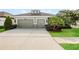 Charming home featuring an attached two-car garage, landscaped yard, and welcoming curb appeal at 13408 Nimble Minke # 155E, Riverview, FL 33579