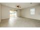 Bright living room featuring tile flooring, recessed lighting, and sliding glass doors to the backyard at 13408 Nimble Minke # 155E, Riverview, FL 33579