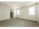 Spacious primary bedroom featuring neutral carpet, plenty of natural light, and an ensuite bathroom at 13408 Nimble Minke # 155E, Riverview, FL 33579