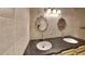 Bathroom with ornate mirrors, double sinks, and decorative tile at 1421 Mohrlake Dr, Brandon, FL 33511
