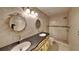 Bathroom with ornate mirrors, double sinks, and decorative tile and a glass enclosed shower at 1421 Mohrlake Dr, Brandon, FL 33511