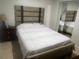 Bedroom featuring a modern headboard and mirrored closet doors at 1421 Mohrlake Dr, Brandon, FL 33511