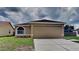 Charming single-story home with a well-maintained lawn and attached two-car garage at 1421 Mohrlake Dr, Brandon, FL 33511