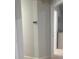 Hallway with thermostat and view of the bathroom with white painted walls at 1421 Mohrlake Dr, Brandon, FL 33511