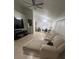 Open-concept living room features a ceiling fan and a large sectional sofa at 1421 Mohrlake Dr, Brandon, FL 33511