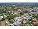 Expansive aerial view of a neighborhood showcasing lush greenery, residential homes, and solar panels at 1445 Coburn Dr, Tarpon Springs, FL 34689