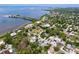 Panoramic aerial view of waterfront homes, lush trees, and a serene bay, creating a tranquil landscape at 1445 Coburn Dr, Tarpon Springs, FL 34689