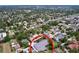 Aerial view of property in a neighborhood setting with lush green landscaping and mature trees at 1445 Coburn Dr, Tarpon Springs, FL 34689