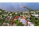 Aerial view showcasing the property's backyard pool, fence and proximity to the nearby bay at 1445 Coburn Dr, Tarpon Springs, FL 34689