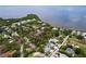Aerial shot showcasing residential area near waterfront with tennis courts and lush greenery at 1445 Coburn Dr, Tarpon Springs, FL 34689