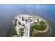 Overhead view of an island park with sandy beaches, lush palm trees, and clear waters surrounding at 1445 Coburn Dr, Tarpon Springs, FL 34689