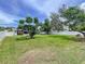 Large grassy backyard with privacy fence and mature trees at 1445 Coburn Dr, Tarpon Springs, FL 34689