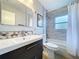Updated bathroom featuring a modern vanity, stylish shower, and decorative tile accents at 1445 Coburn Dr, Tarpon Springs, FL 34689