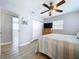 Comfortable bedroom with a ceiling fan, closet, and a television on a chest of drawers at 1445 Coburn Dr, Tarpon Springs, FL 34689