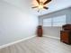 This bedroom features wood-look floors, fresh paint, and a ceiling fan at 1445 Coburn Dr, Tarpon Springs, FL 34689