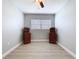 This bedroom features wood-look floors, fresh paint, and two antique matching cabinets at 1445 Coburn Dr, Tarpon Springs, FL 34689