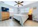 Inviting bedroom featuring natural lighting, a ceiling fan, and comfortable furnishings at 1445 Coburn Dr, Tarpon Springs, FL 34689