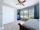 Bright bedroom with closet, ceiling fan, and large sunny window at 1445 Coburn Dr, Tarpon Springs, FL 34689