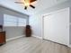Bedroom with ceiling fan, new floors, and closet at 1445 Coburn Dr, Tarpon Springs, FL 34689