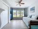 Bright bedroom with closet, ceiling fan, and large sunny window at 1445 Coburn Dr, Tarpon Springs, FL 34689