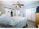 Comfortable bedroom features a ceiling fan and access to ensuite bathroom and closet at 1445 Coburn Dr, Tarpon Springs, FL 34689