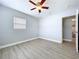 Bright bedroom with ceiling fan and new floors at 1445 Coburn Dr, Tarpon Springs, FL 34689