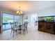 Dining room table with view to a lanai, modern lighting, and a fish tank at 1445 Coburn Dr, Tarpon Springs, FL 34689
