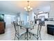 Dining room with decorative table and view to the kitchen and front door at 1445 Coburn Dr, Tarpon Springs, FL 34689