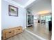 Welcoming entryway leading to an open-concept kitchen and dining area, featuring a decorative cabinet at 1445 Coburn Dr, Tarpon Springs, FL 34689