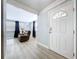 Inviting foyer with neutral walls and flooring leading to the living room at 1445 Coburn Dr, Tarpon Springs, FL 34689