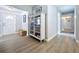 Inviting hallway with bright lighting and decorative display cabinet at 1445 Coburn Dr, Tarpon Springs, FL 34689