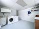 This laundry room has white walls, a water heater, and a washer and dryer set at 1445 Coburn Dr, Tarpon Springs, FL 34689