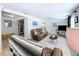 Inviting living room with leather seating, neutral rug, and bright walls with a view to another room at 1445 Coburn Dr, Tarpon Springs, FL 34689