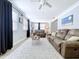Spacious living room with wood-look floors, neutral walls, and comfortable couches at 1445 Coburn Dr, Tarpon Springs, FL 34689