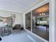 Cozy enclosed patio with decor, table and chairs and sliding glass door at 1445 Coburn Dr, Tarpon Springs, FL 34689
