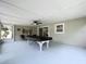 Enclosed patio with neutral paint, a pool table, ceiling fan, and sliding glass doors provide indoor/outdoor living at 1445 Coburn Dr, Tarpon Springs, FL 34689