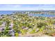 Areal view of neighborhood with beautiful blue water and a clear blue sky, city in the distance at 1518 Cheyenne Ne St, St Petersburg, FL 33703