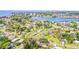 Expansive aerial view of a waterfront neighborhood with lush greenery and the city skyline in the distance at 1518 Cheyenne Ne St, St Petersburg, FL 33703