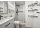 Updated bathroom featuring a modern vanity, marble shower, and floating shelves for storage at 1518 Cheyenne Ne St, St Petersburg, FL 33703